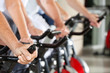 Beschreibung: Hände an Spinning-Rädern im Fitnesscenter